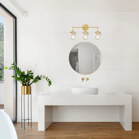 Gracelyn Satin Gold 3-Light Bathroom Vanity Light With Clear Seedy Glass Globes above modern white vanity, sleek and elegant setup.
