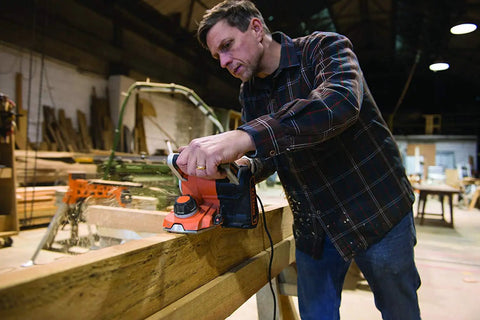 Man using Beast 750W 2 in 1 Electric Wood Planer And Sander with 17 Position Depth Control in workshop.