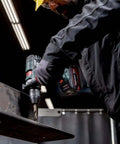 User operating Tough As Nails 18V Cordless Power Drill With Supra SK Drill Chucks on a steel beam in a workshop.