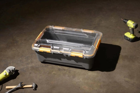 Toss Your Gear In This Heavy Duty 5.28 Gallon Waterproof Plastic Storage Tote Bin with orange latches on a concrete floor.