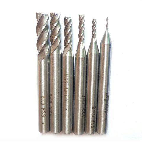 Six silver 4-flute CNC end mills (HSS) with cylindrical shanks, front view for metal milling