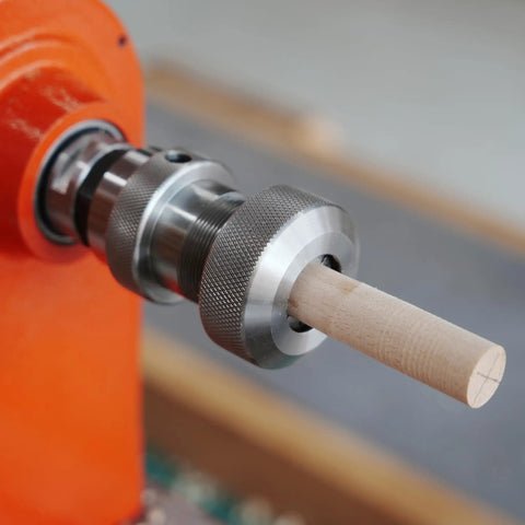 Crush Complex Turns On Your Lathe With This Badass ER32 Collet Chuck Kit featuring a wooden blank secured in a silver collet chuck.