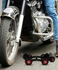 Amosfun Motorcycle Tire Dolly Tool With Five Smooth Wheels Heavy Duty Vehicle Mover For Electric Bikes Scooters And Tricycles Effortless Transport Roller For Garage Emergency Flat Tire Repair And Maintenance positioned near a motorcycle tire.