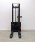 Heavy Duty Electric Thin Leg Pallet Stacker viewed from the front, showcasing lift mechanism and forks for warehouse use.