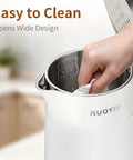Person cleaning Grab And Go Travel Ready Electric Kettle 0.8L, Ultra Portable Double Wall Stainless Steel Boiler with 304 Food Grade Seamless Inner Tank.