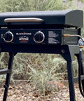 Blackstone tabletop griddle with Propane Adapter Hose And Regulator Conversion Kit 1Lb To 20Lb connected outdoors.