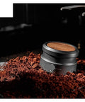 Top Shelf Espresso Tamper And Coffee Distributor Combo with dual stainless blades on coffee grounds, highlighting detailed design.