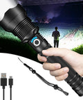 Person holding Beast Mode 90,000 Lumens Rechargeable LED Flashlight With Zoomable Beam, showing bright beam and USB cable.