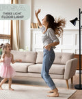 Woman and child dancing in living room with Black Tree Floor Lamp With Three Adjustable Heads For Living Room, Bedroom, And Office