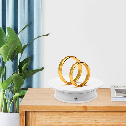 Must Have Electric Rotating Display Turntable With 360 Degree Spin, Auto Speed Control, And Suede Base showcasing two gold rings.