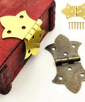 Set Of Six Mini Butterfly Cabinet Hinges In Classic Antique Gold With Included Mounting Screws For Wood Boxes Jewelry Crafts And Furniture Diy No Sweat Install And Built Tough attached to a wooden box.