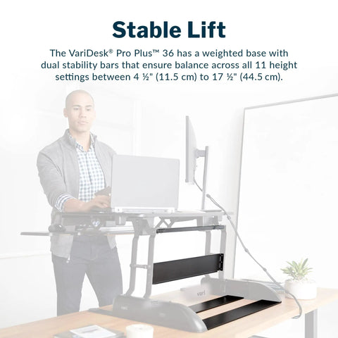 Person using Pro Plus 36 Adjustable Desk Converter With 11 Height Settings for Dual Monitor, mounted on desk.