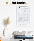 White Plastic Clipboard With Pen Holder And Low Profile Clip 12.5 By 9 Inch Writing Surface A4 And 8.5 By 11 Inch Letter Size Durable Polypropylene Clipboard For Nurses Students Office And On The Go hanging on wall with documents.