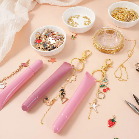 DIY Lip Gloss Keychain Craft Kit With Enamel Charms And Chains Pliers Hole Punch Jump Rings Gift Bags 333 Piece All In One Jewelry Making Set with tubes and charms displayed.