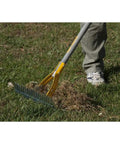 Person using Thatch Rake For Lawns With Curved Steel Tines 15 Inch Brown All In One Lawn Care Tool For Dethatching Aerating Seeding