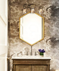 Vintage Vanity Light Fixture Rustic Bathroom Wall Sconce Three Light With Amber Glass Shade above mirror in cozy bathroom.