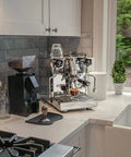 Espresso Machine And Eureka Mignon Silenzio 55 Grinder Bundle in stainless steel and chrome finish on a kitchen countertop.
