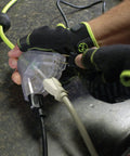 Gloved hand using Retractable 25 Ft Extension Cord Reel With 16/3 SJTOW Oil Resistant Cable, Lighted Triple Tap Outlet.