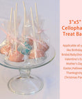 Clear 3x5 Inch Cake Pop Bags With Twist Ties, Lollipop Bags For Cookies Candies And Treats, 100 Pack, displayed on a plate