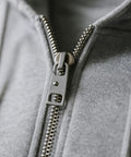Close-up of a jacket with a metal zipper, showing Eleven Pieces Zipper Pull Replacement Set Heavy Duty Metal Zipper Repair Kit Detachable Pull Tabs