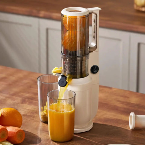 Aynefy 200W Cold Press Juicer With Wide Feed Chute For Whole Fruits extracting fresh orange juice into glasses on kitchen counter.
