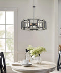 Rustic 24 Inch 5 Light Farmhouse Chandelier With Adjustable Hanging Height In Gray Oak Wood Look And Sandblasted Black Finish, Open Geometric Frame in dining room setting.