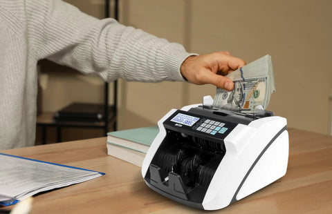 High Speed Money Counter With Multi Currency Detection, Counterfeit Bill Detector with LCD Display on a desk in use