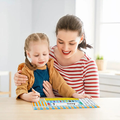 Child using Self Adhesive Classroom Nameplates With Alphabet Chart, Numbers And Addition Chart, Shapes And Colors at desk