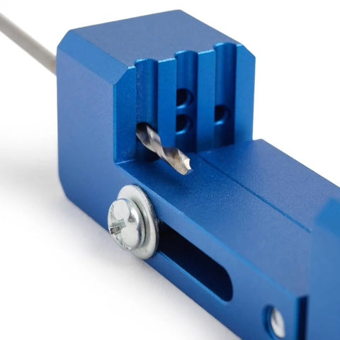 Close-up of a blue aluminum Derby Car Drill Jig For Precise Axle Holes Create Straight Or 2.5 Degree Angled Holes And Raised Wheel Holes.