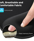Close-up of finger pressing memory foam on ergonomic mouse pad with wrist rest, showcasing breathable fabric.
