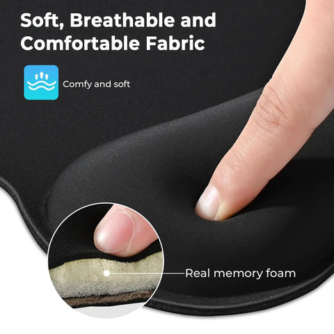 Close-up of finger pressing memory foam on ergonomic mouse pad with wrist rest, showcasing breathable fabric.