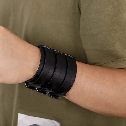Fresh Hip Hop Drip Wide PU Leather Cuffs For Men Adjustable Punk Rock Gothic Wrists Band Pair Black on wrist with casual shirt