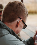 Person wearing Ion Pro 2 Bluetooth Rechargeable OTC Hearing Aids for Seniors with App Control, seen from the side