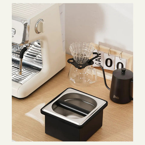 Built Like A Tank Stainless Steel Knock Box With Removable Interior Grounds Bin For Espresso Setups and Home Baristas on a countertop.