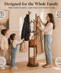 Family using Rotating Coat Rack Freestanding With 9 Hooks And 3 Shelves, Heavy-Duty Rubberwood Hall Tree In Walnut Finish