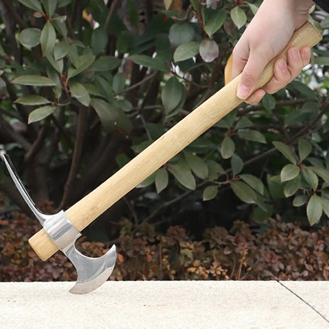 Person holding Stainless Steel Double Headed Pickaxe With Wood Handle And Comfort Grip For Easy Digging in a garden setting