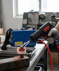 Professional 1500W Magnetic Induction Heater For Kicking Loose Seized Bolt Nut Screw And Bearing Remover in use on a rusted bolt.
