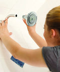 Person installing Earth Luxe High Efficiency Showerhead With 1.25 GPM Flow Chrome Finish Three Spray Settings in bathroom
