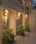 Outdoor view with lit Rustic Mason Jar Wall Lights With Remote, Battery Powered Sconce Set Of 2 on brick wall.