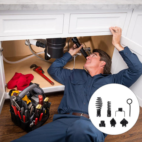 Man working under a sink with tools, featuring 7 Piece Heavy Duty Steel Drain Auger Blades For Bustin Open Stubborn Clogs And Keeping Your House Pipes Running Smooth Works Perfect With Spinal Snake Machines Kitchen Bath Drain Cleaner Kit.
