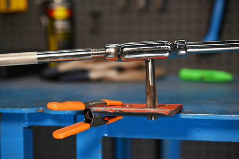 High Carbon Steel Fractional Plug Tap 3/4-10 NC installed on a workbench for threading, ideal for hand and machine tools.
