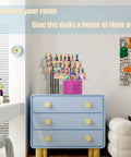 Ultimate Pink Metal Toniebox Stash Holder For 20 To 35 Tonies with dolls displayed on a blue dresser in a modern room.
