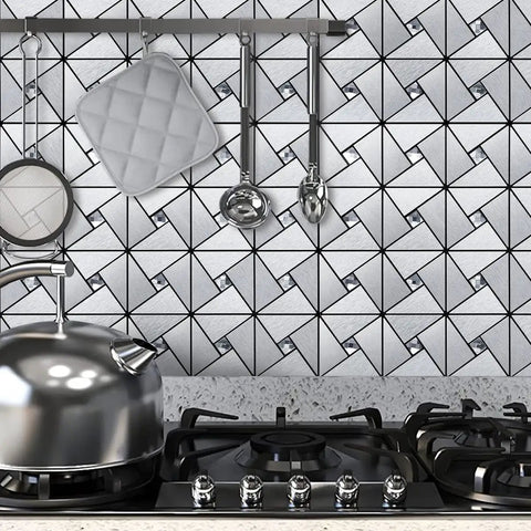 10-Sheet Peel And Stick Backsplash Tile Set For Kitchen Fireplace And Bathroom Windmill Glass In Brushed Silver Aluminum Composite 3D Metal Look With Ultra Strong 3M Adhesive installed in kitchen with stove and utensils