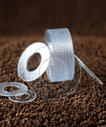 Stack of transparent PVC hard washers in various sizes from M1.2 to M20 for screw insulation and vibration isolation applications.