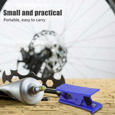 Front view of blue plastic bike hydraulic brake hose cutter tool on a wooden surface