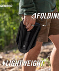 Person holding Military Style Tactical Folding Spade E Tool for Camping and Emergency Car Use, Heavy Duty All Purpose Shovel With Serrated Edge.