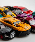 Close-up of colorful diecast cars in a row, suitable for Two Pack 1 By 64 Scale Wheels And Tires With Real Riders Rims and upgrades.