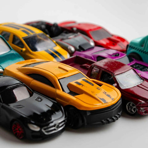 Four Pack 1 64 Scale Wheel And Tire Set For RC Diecast Cars with various colorful diecast models, close-up view