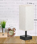 Small Table Lamp For Bedroom And Nightstand With Square Fabric Shade on wooden desk near clock and plant, minimalist design.