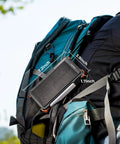 Solar Power Bank With Hand Crank And Four Cables 20000mAh Wireless Portable Charger on a backpack outdoors